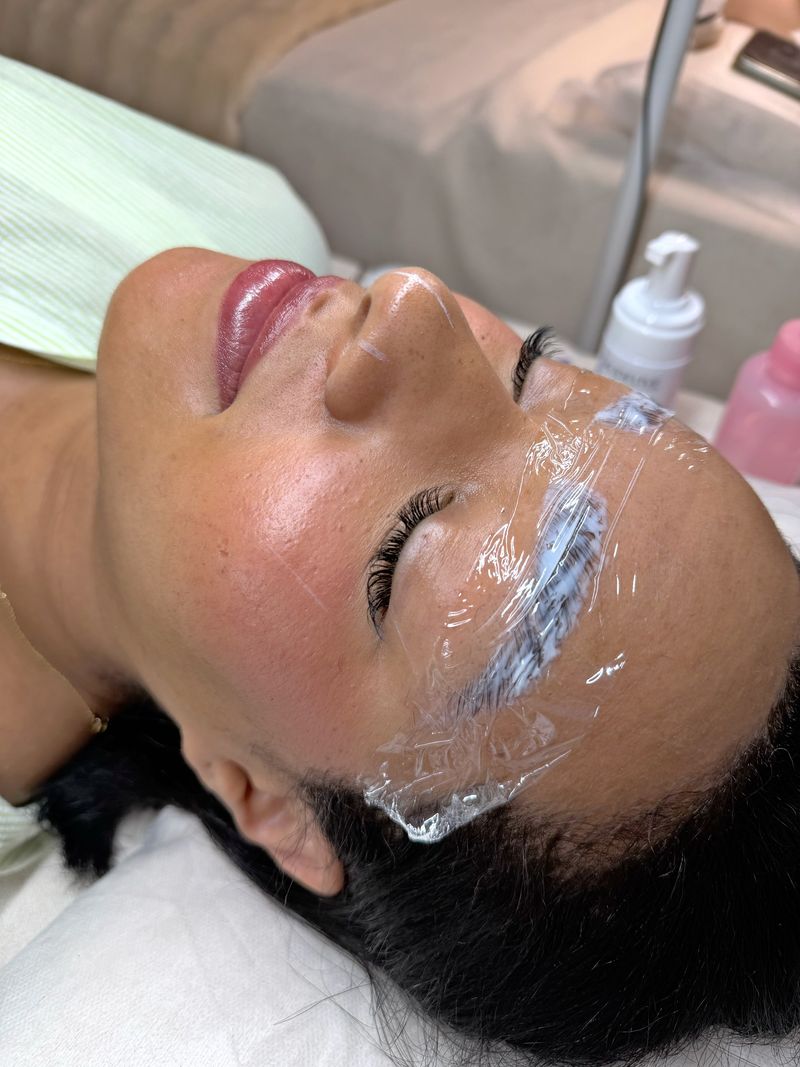 Brow lamination in progress, the brows set under film, at Shella Nails & Lashes, Da Nang