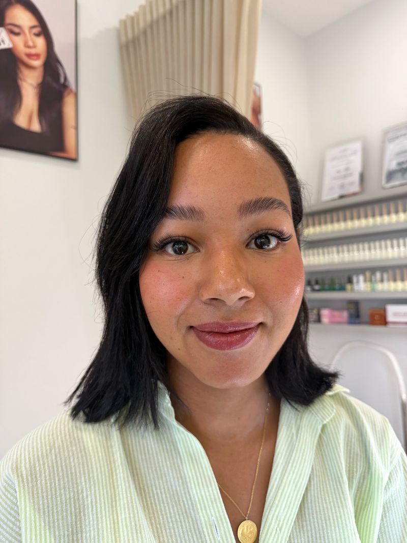 A client smiling after her lash appointment at Shella Nails & Lashes, Da Nang