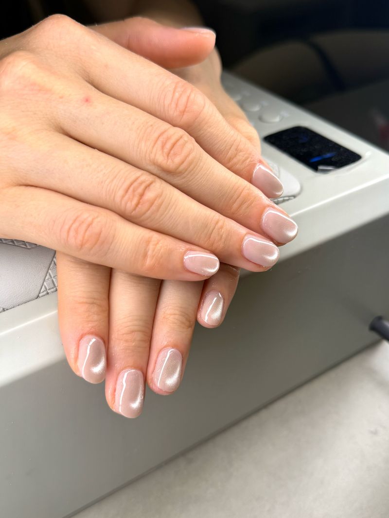 Short almond nails with a sheer pink chrome finish at Shella Nails & Lashes, Da Nang