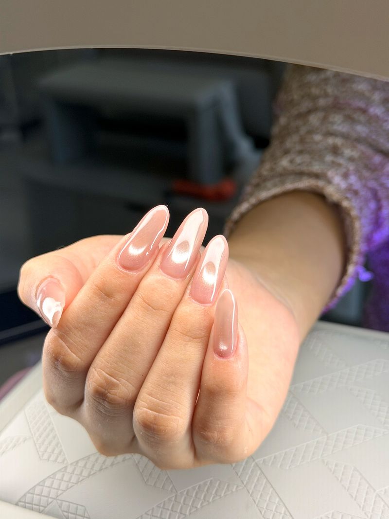 Long almond nails in a glossy nude-pink chrome